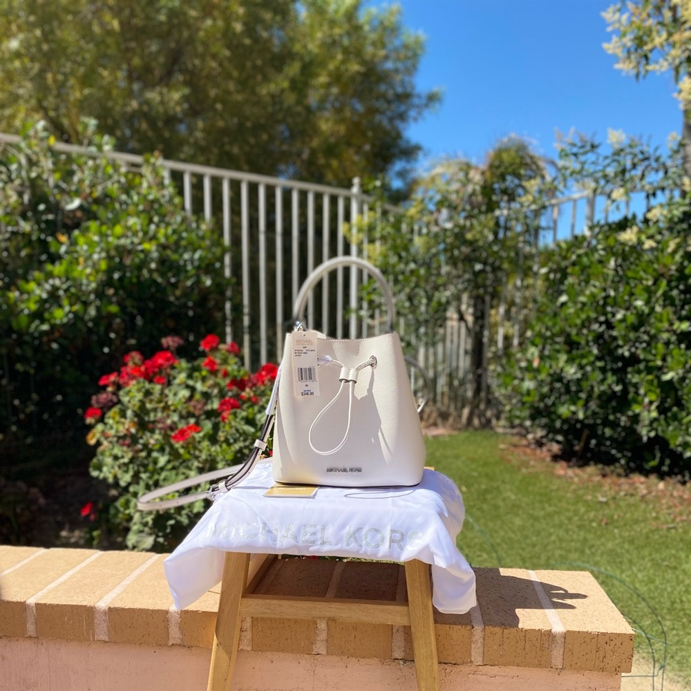 Michael Kors brand New with Tags.  White saffiano leather Suri White Bucket.